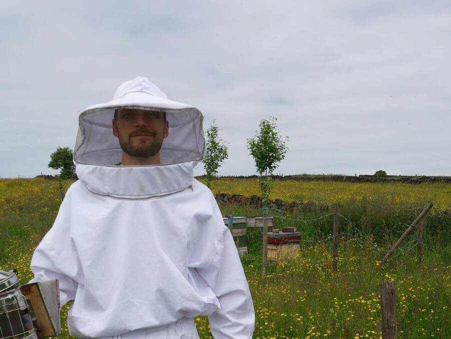 Australian National University biologist Dr Luke Holman in the field, literally, researching bees. Photo: Supplied