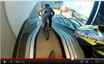 Two young men riding bikes down escalators in Canberra shopping centres seen on YouTube.