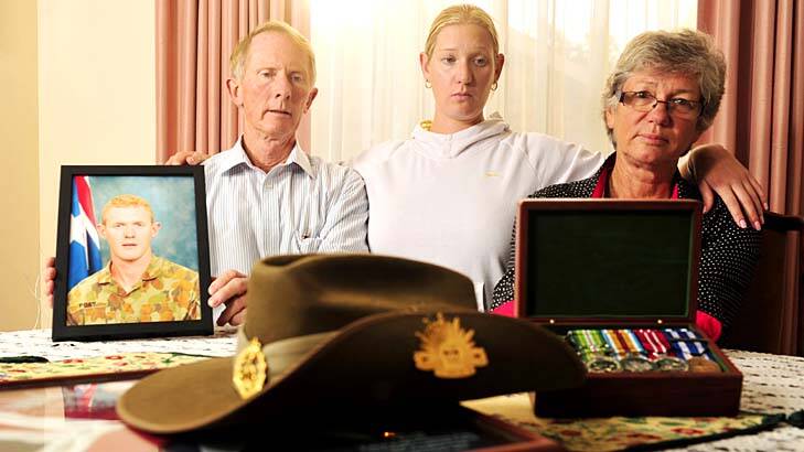 The parents and sister of killed soldier Private Robert Poate, Hugh, left, Janny, right, and their daughter Nicola, centre, in there Garran home. Photo: Jay Cronan