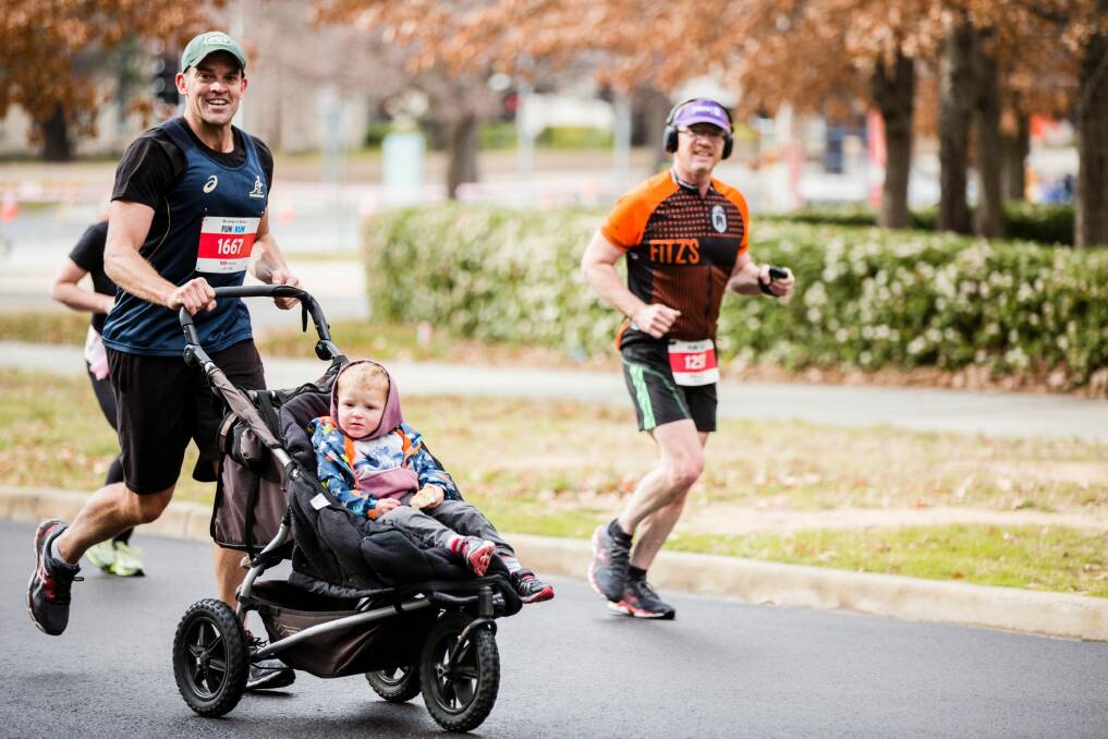 Dan Kite pushed a pram in the 14-kilometre race at The Canberra Times Fun Run. Photo: Jamila Toderas
