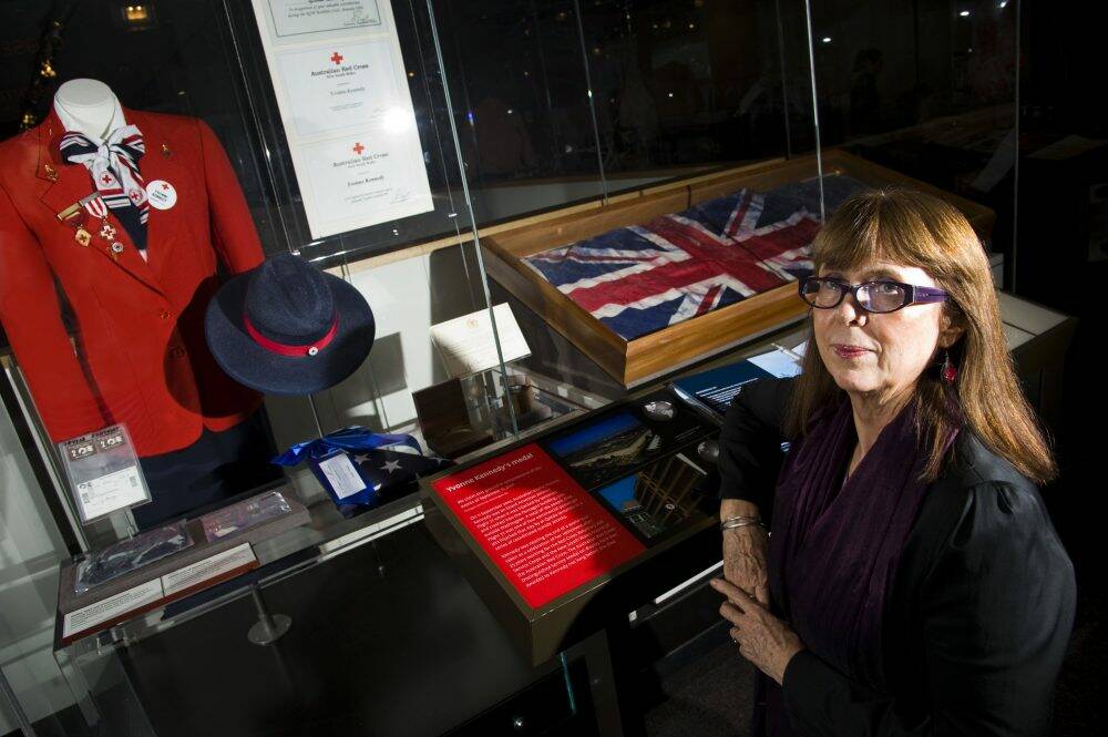 National Museum of Australia curatorial fellow Carol Cooper with a display that honours Australian Red Cross volunteer Yvonne Kennedy, who died in the September 11, 2001, terrorist attacks. Photo: Elesa Kurtz