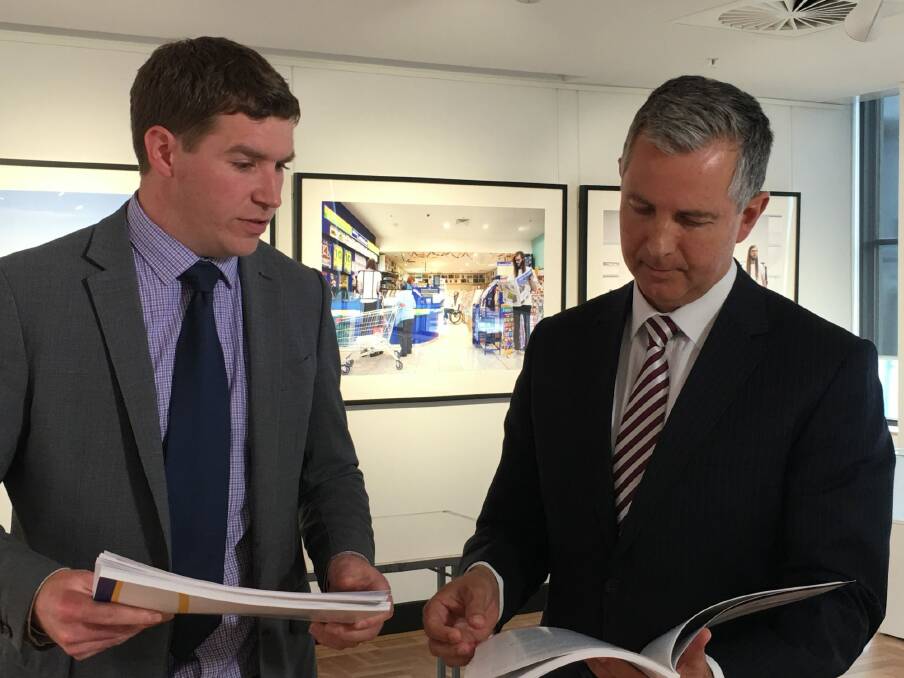 The Liberals' deputy leader Alistair Coe and leader Jeremy Hanson examine the audit report into the Land Development Agency's City to the lake purchases. Photo: Kirsten Lawson