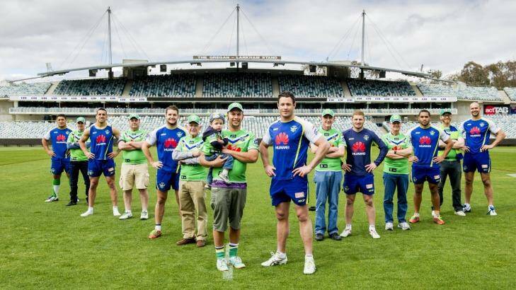 A select group of dedicated Canberra Raiders fans wearing Saturday’s game jerseys with their names embroidered on the chest, which will be worn by the players. Pictured from left are Josh Papalii, fan Tim Keed,  Paul Vaughan, fan Ralph Bradbury,  Jarrod Croker, fans Ron Bartier, Eli, 2, and father Mitchell Keegan, Brett White, fan Ron Kropp, Glen Buttriss, fan Jeff Boag,  Bill Tupou, fan Lachlan Cameron and Dane Tilse. Photo: Jay Cronan