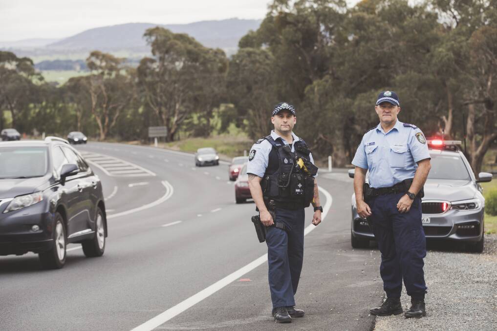 ACT Policing's Dave Wills and NSW Police's Angus Duncombe on the Kings Highway. Photo: Jamila Toderas