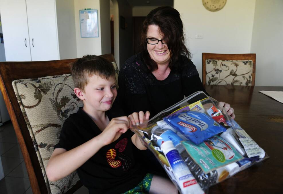 Grace Stephenson with her son Koda, six, with one of the blessing bags they have created. Photo: Melissa Adams