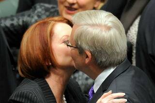 Then Prime Minister Julia Gillard hugs and kisses foreign minister Kevin Rudd after the carbon tax legislation was passed in the House of Representatives. Photo: Reuters