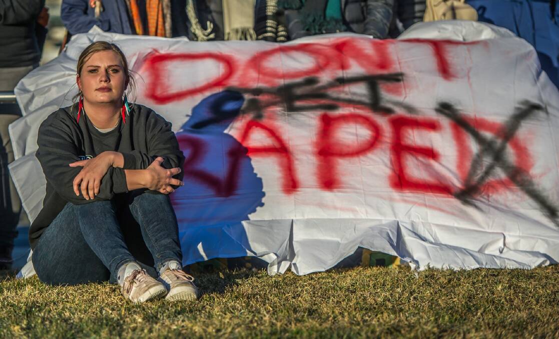 Sexual assault victim Freya protests on the lawns outside Parliament House. Photo: Karleen Minney