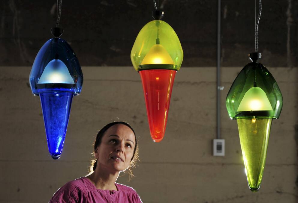 Curator of the GlassX Design exhibition at the Canberra
Glassworks, Magda Keaney, with one of the exhibits, <i>Studies in
Scream </i> by glass artist George Agius and designer Jason Bird.  Photo: Graham Tidy