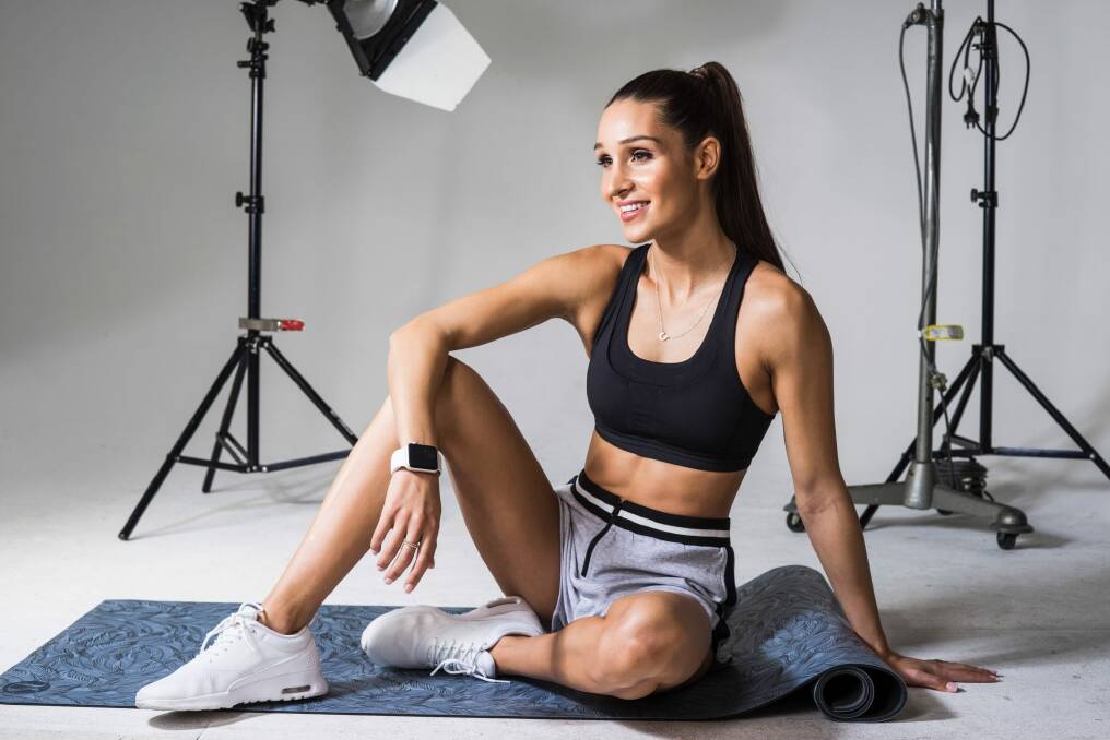 Bikini Body Training Company creator Kayla Itsines cracked a number of world records with more than 2200 of her fans. Photo: Nick Clayton