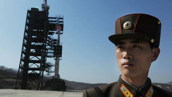 Missile controversy... a North Korean soldier stands guard in front of an Unha-3 rocket at Tangachai -ri space centre in April. Photo: AFP