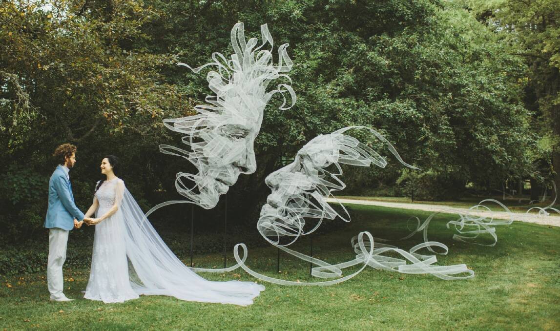 Benjamin Shine and Danielle Stone on their wedding day next to ribbon sculpture "Entwined" by Benjamin Shine. Photo: Lilli Waters