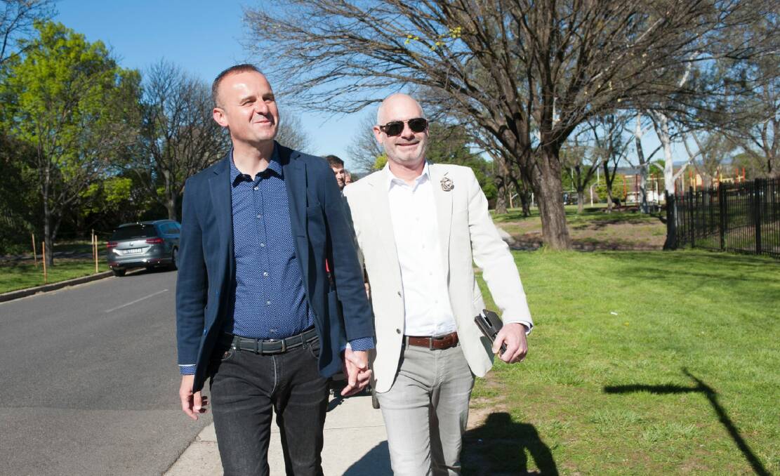 Chief Minister Andrew Barr votes at Ainslie North Primary School with partner Anthony Toms.  Photo: Elesa Kurtz