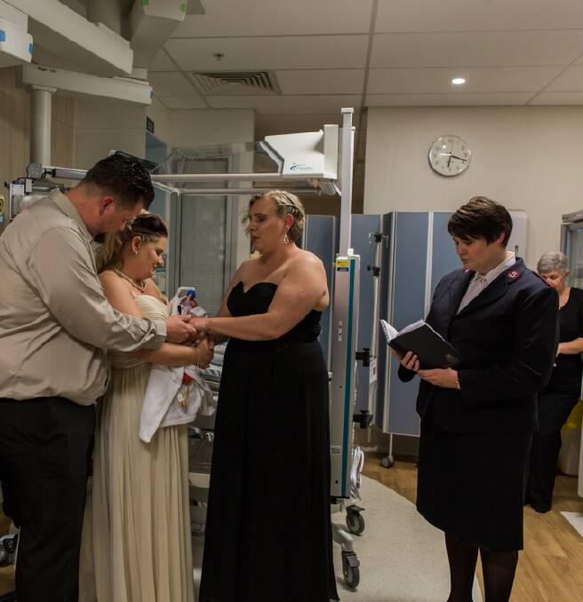 James and Kylie Wiggins of Macarthur with their baby son Dolton at their wedding in the Neonatal Intensive Care Unit at the Canberra Hospital. Also pictured is ,aid of honour and Kylie's sister Carissa Dockary and minister and Kylie's aunt Sandy Macdonald. Photo: Genevieve Dahl Photograpy