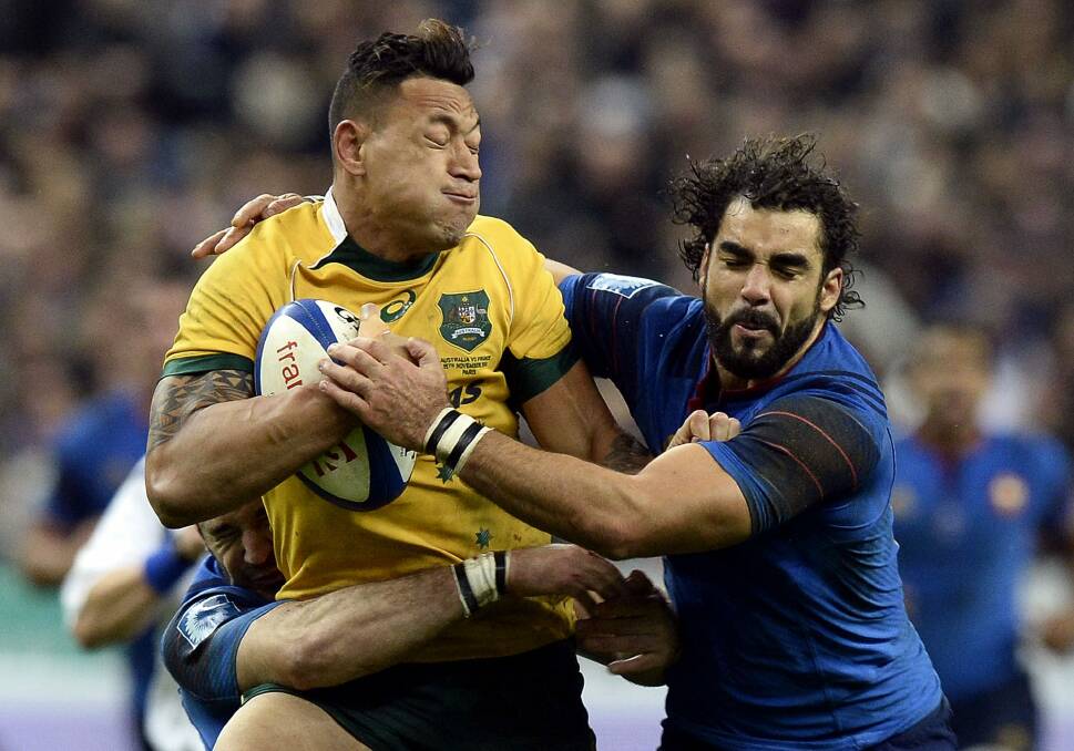 Flat performance: Israel Folau is tackled by the French defence.
