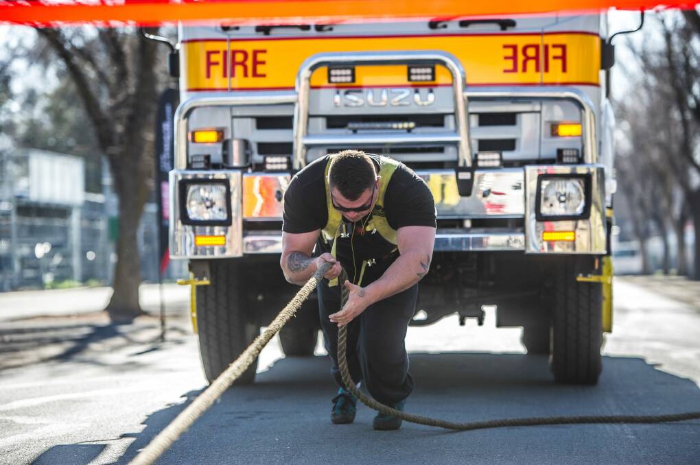 Canberra Big Boys Toys Expo 2016 Media Launch- Canberra strongman Andrew Fraser pulls a fire-truck under his own steam. Photo: Karleen Minney