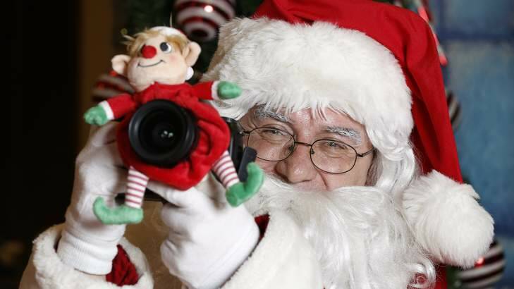 Santa (Rick Goode) tries to get his own photo of the Canberra Times photographer after a long day at David Jones. Photo: Jeffrey Chan