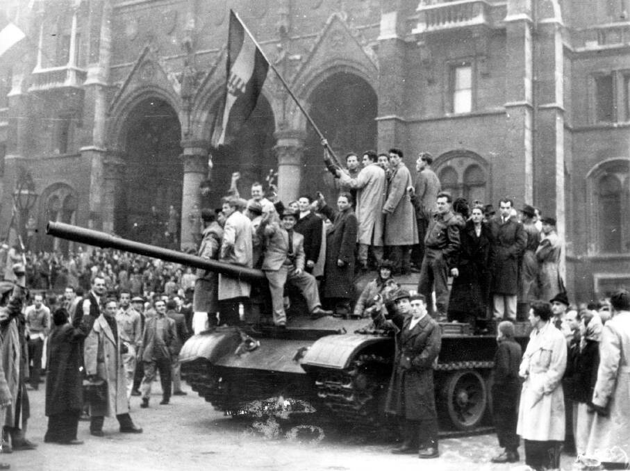 Hungarian rebels wave their national flag from a tank captured in the main square of Budapest, Hungary, in 1956.