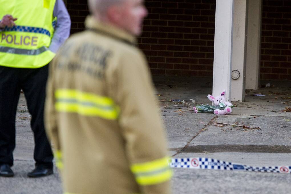 Police and ACT Fire & Rescue crews outside the Queanbeyan unit where a fire claimed the life of a one-year-old girl. Photo: Jay Cronan
