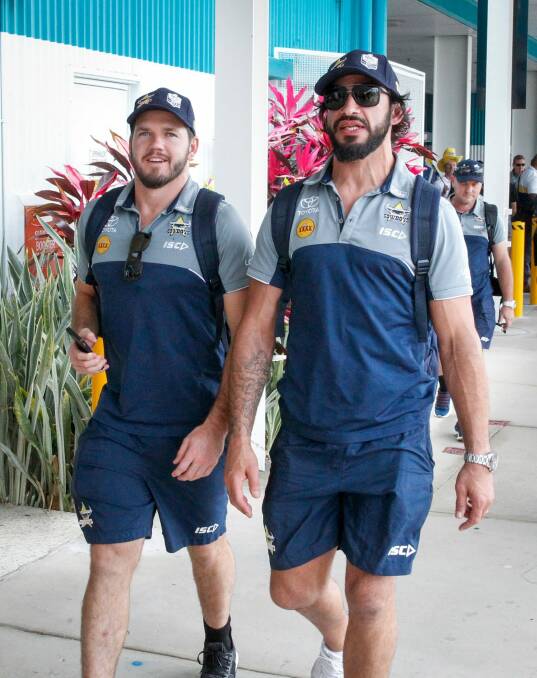 Lachlan Coote and Johnathan Thurston of the Cowboys are greeted by fans at the Townsville Airport. Photo: AAP