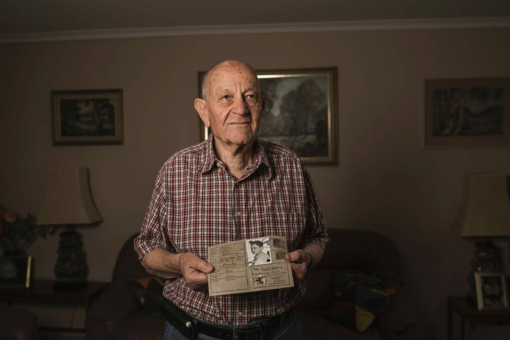 Holocaust survivor Peter Witting holds his Jewish identity card.  Photo: Jamila Toderas