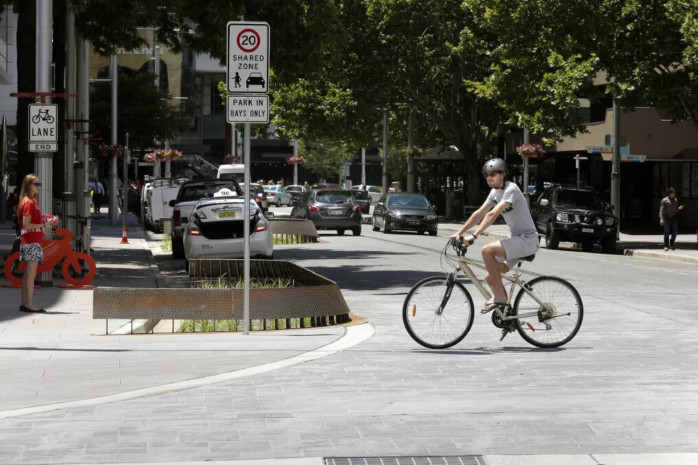 Student Clinton Madden rides his bike across one of the raised intersections on Bunda Street. Photo: Jeffrey Chan