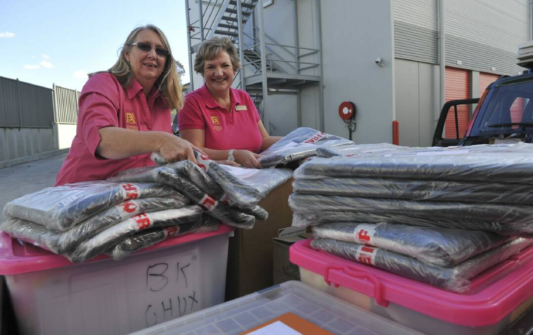 Grace Slater (left) and Faye Tripovich pack a car trailer full of birthing kits.  Photo: Photo: Graham Tidy