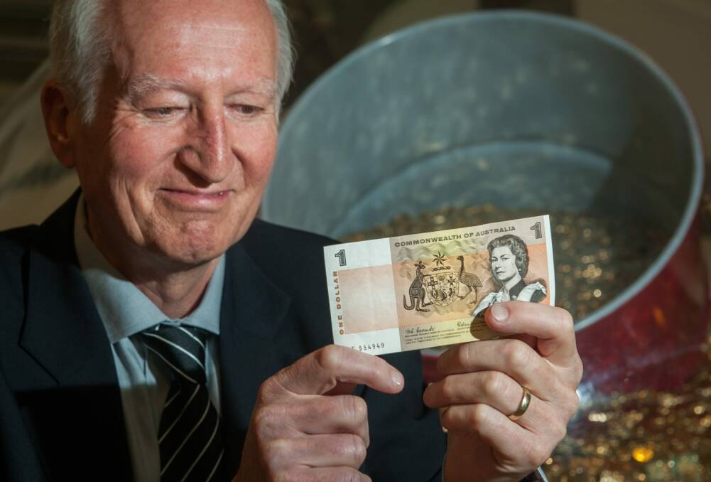 Canberra author Peter Rees at the Royal Australian Mint with a $1 note he received in his first pay packet in the same week Australia converted to decimal currency. Photo: Elesa Kurtz