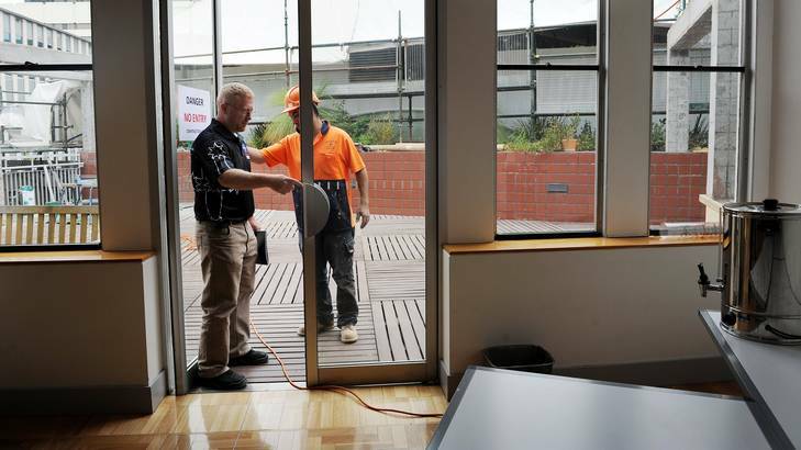 CFMEU secretary Dean Hall talks to a worker about unsafe building practices at the ACT Legislative Assembly on Monday. Photo: Colleen Petch