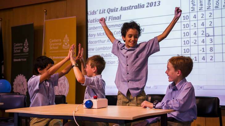 Canberra Grammar Primary school students, Nick Barnard, James Rogers, Leo Barnard, and James Phillips, celebrate a correct answer at the Australian finals of the Kids Lit Quiz. Photo: Rohan Thomson