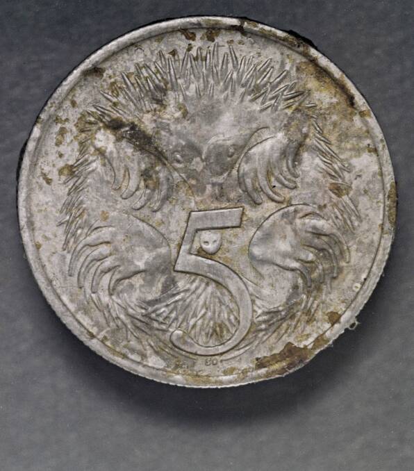 A five cent coin after its 1966 ordeal.  Photo: National Archives.