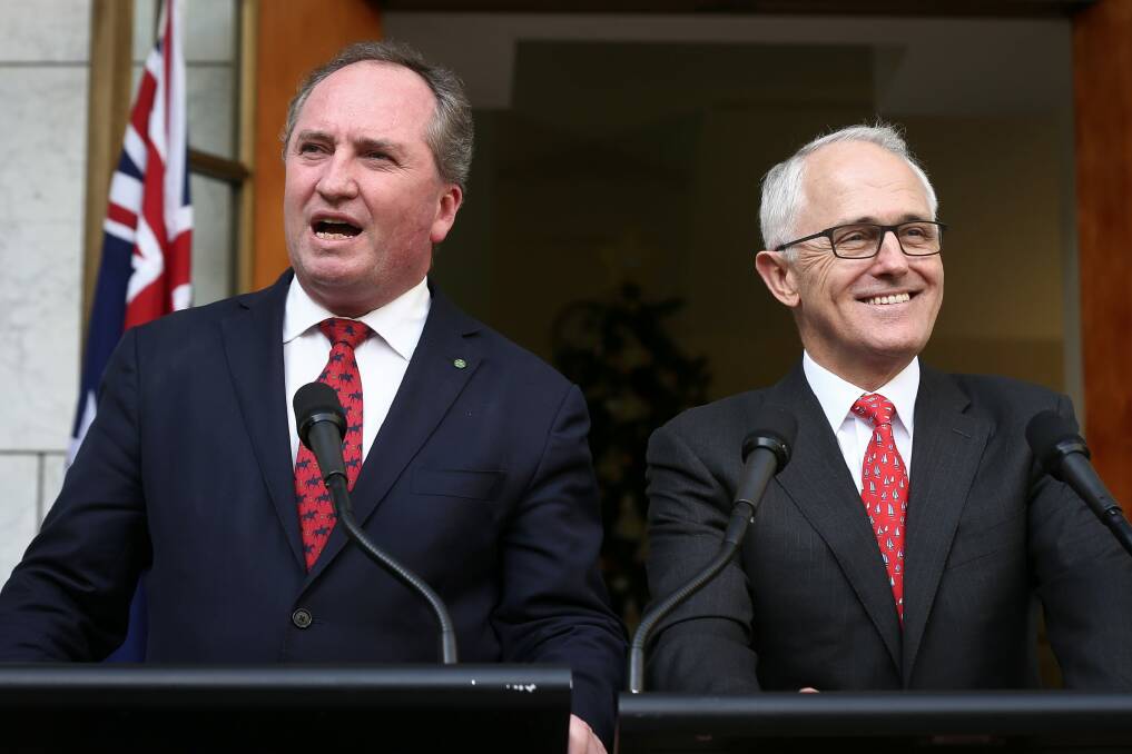 Barnaby Joyce and Malcolm Turnbull are all smiles as they announce the Greens deal on the backpacker tax. Photo: Alex Ellinghausen