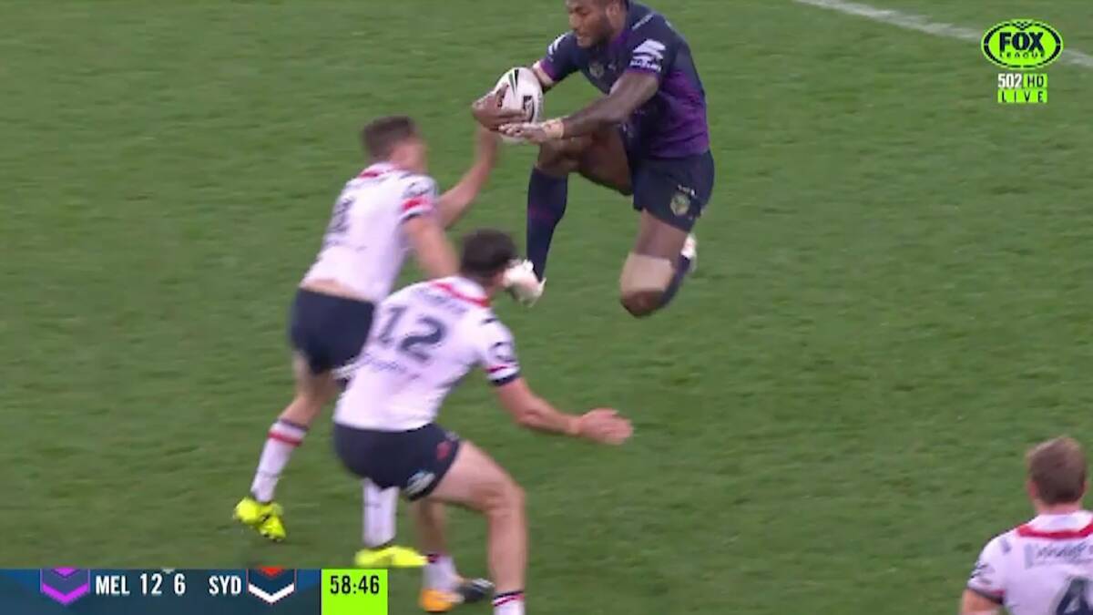 'How do you comment on that?' Melbourne's Suliasi Vunivalu leaps with his knees at the Roosters defenders. Photo: Fox Sports
