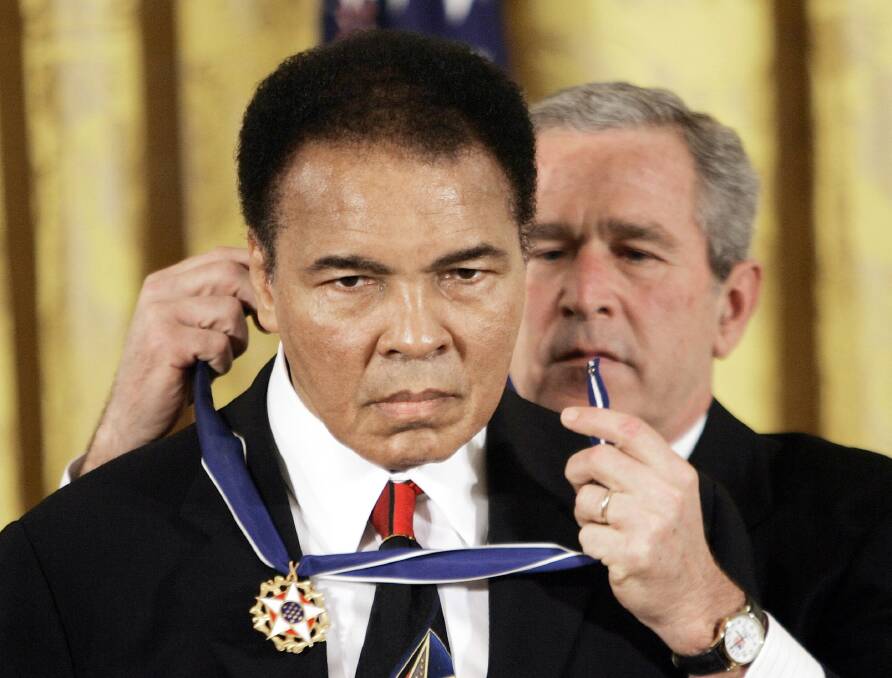 The US president George W Bush presents the Presidential Medal of Freedom to boxer Muhammad Ali in 2009. Photo: AP