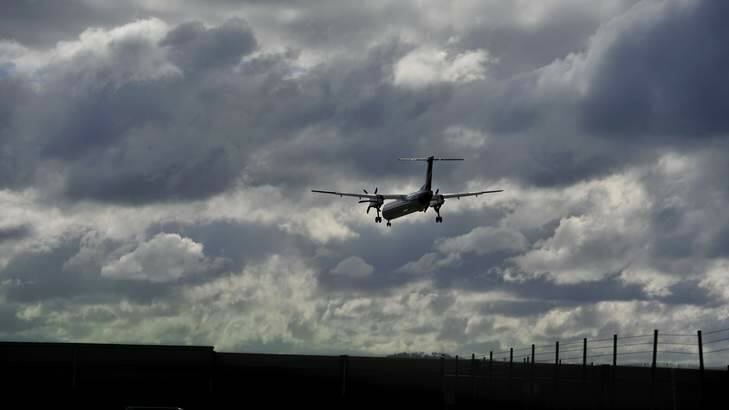 An aircraft coming into land fights the strong cross wind at Canberra Airport. Photo: Jay Cronan