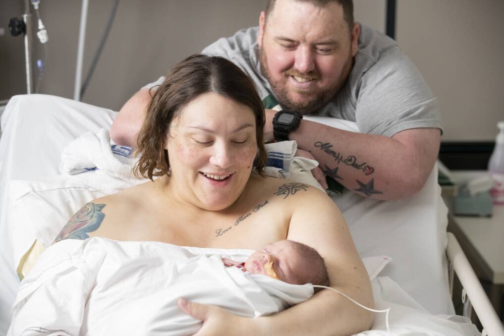 Cassie Woods, pictured above left, and Chris Woods, pictured above right, welcome their son Declan into the world on Christmas morning. Photo: Sitthixay Ditthavong