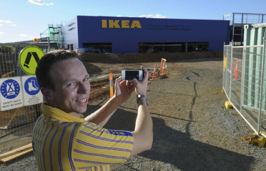 Canberra store manager Mark Mitchinson takes a photo of the familiar IKEA letters at the site at Majura Park. Photo: Graham Tidy