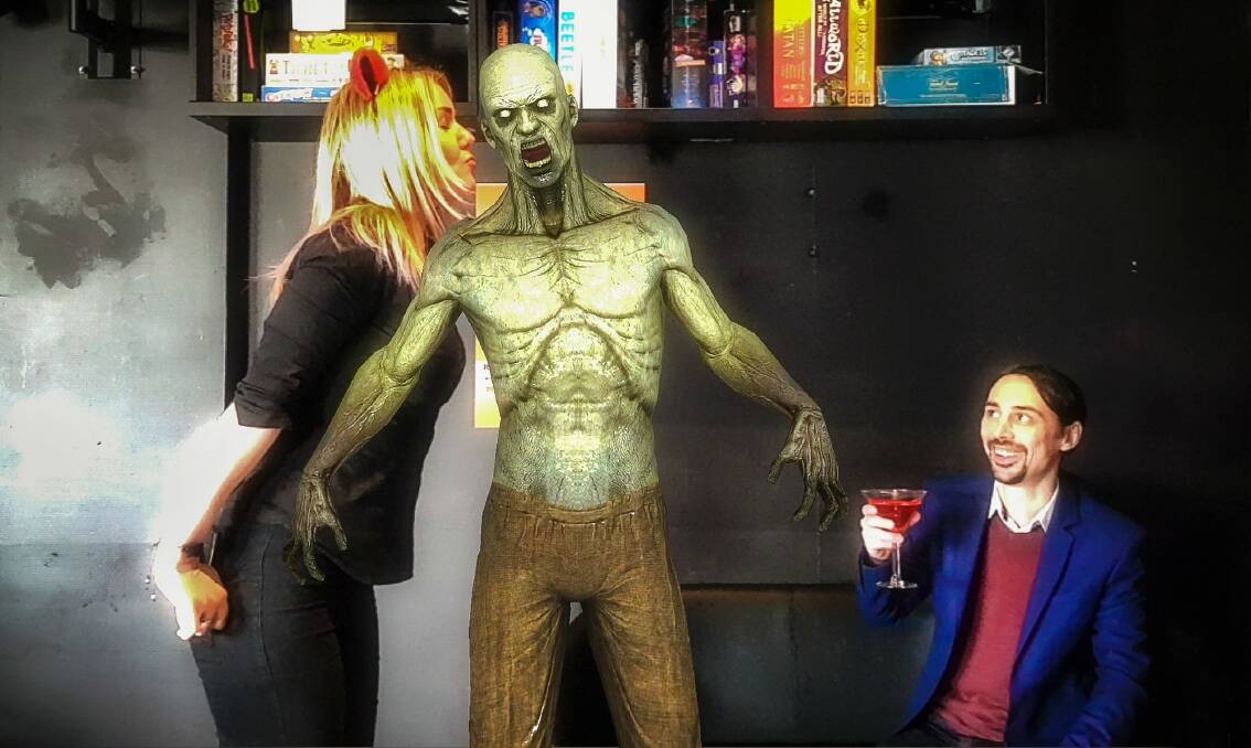 Reload Bar manager Hollie Lehmann and co-owner Jim Andrews kick back with a zombie in Australia's first augmented reality bar. Photo: Sitthixay Ditthavong