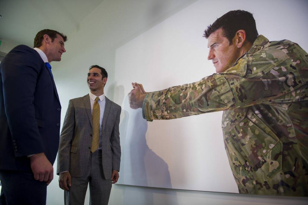 Artist Michael Zavros, right, with one of two portraits of Ben Roberts-Smith VC, MG, left, at the Australian War Memorial.
The Canberra Times Photo: Jay Cronan