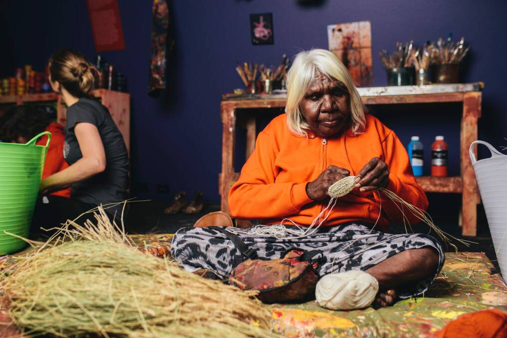 Songlines at the National Museum of Australia Indigenous artist Nola Taylor demonstrating traditional weaving. Photo: Rohan Thomson