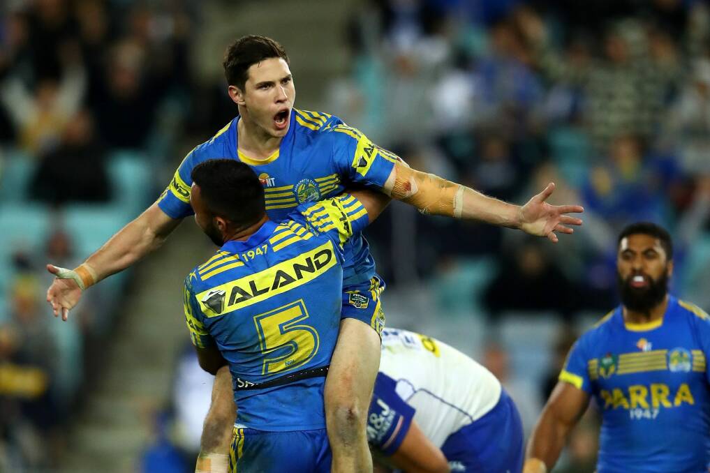 Hearts and minds: Mitch Moses celebrates after kicking the winning field goal in extra-time, winning over Parramatta fans on his way. Photo: Getty Images