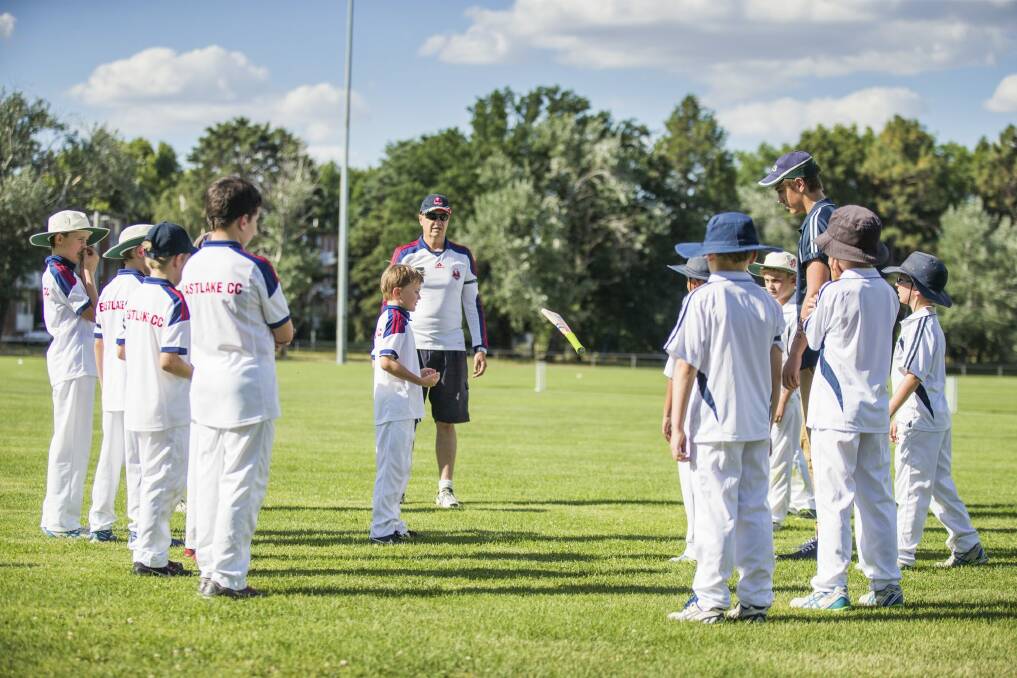 Burgmann Anglican School and Eastlake players spin the bat in their first game after the death of Australian Batsman Phillip Hughes.  Photo: Matt Bedford