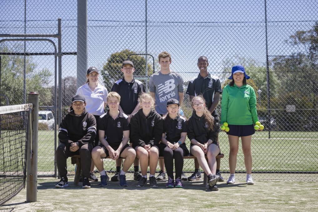 Han Nguyen joins students from Canberra High School as they learn the basics of being a ball kid for the Canberra International.  Photo: Sitthixay Ditthavong