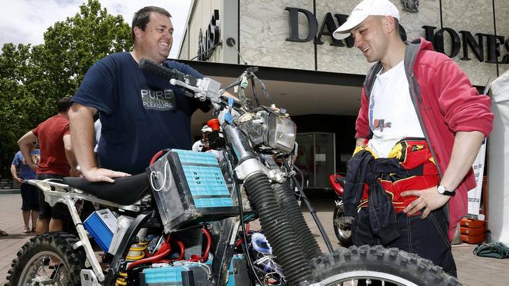 Phillip Carlson of Melba chatting to Al Bunzel of Goulburn about his electric dirt bike "Scrappy". Photo: Jeffrey Chan