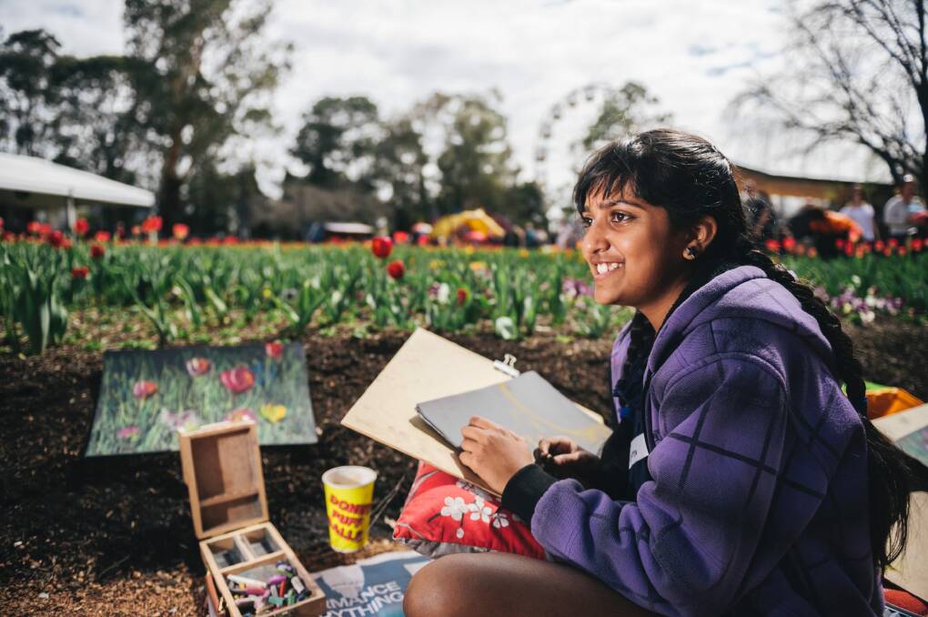 Sowmya Ramanathan, 10, drawing the flowers at Floriade on Saturday. Photo: Rohan Thomson