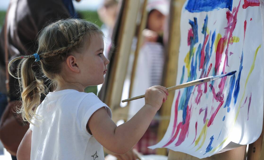 Sienna King, 3, of Red Hill tries her hand at painting. Photo: Graham Tidy