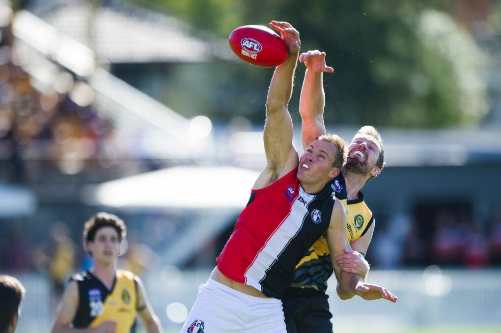 Ainslie's Ben Perry and Queanbeyan's Ryan Quade compete for the ball. Photo: Rohan Thomson