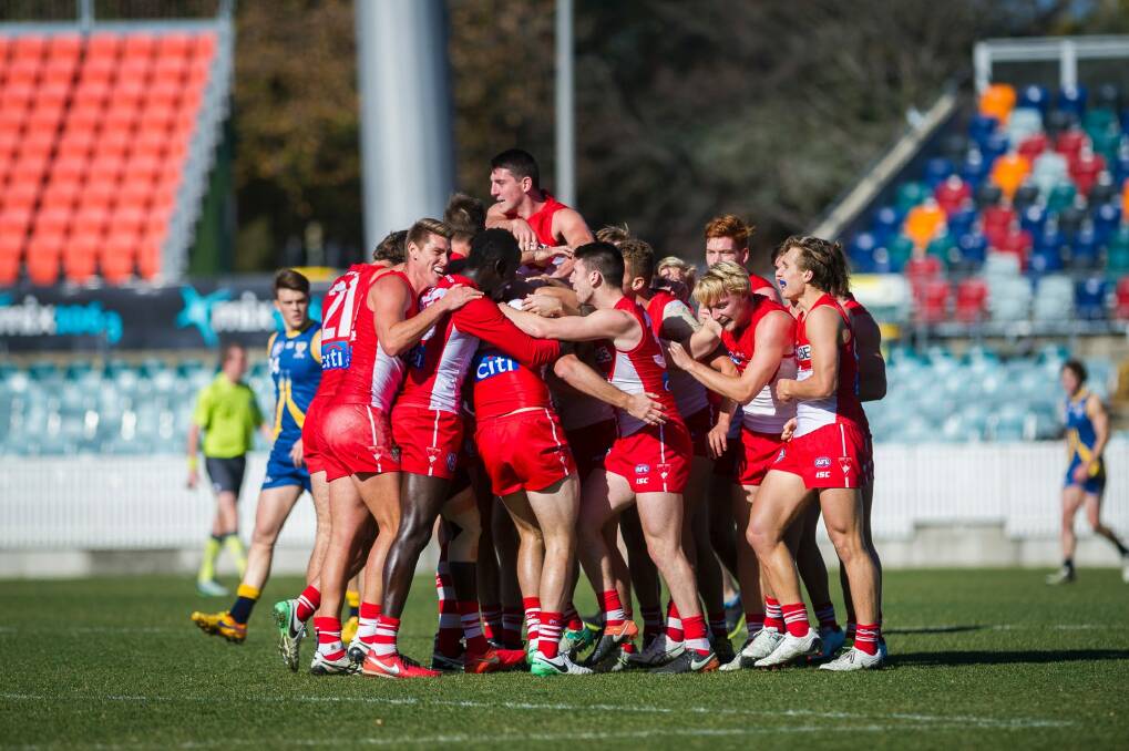 Canberra Demons vs Sydney Swans July 1. Alex Johnson being swarmed by his team mates in celebration after scoring a goal. Photo: Dion Georgopoulos Photo: Dion Georgopoulos