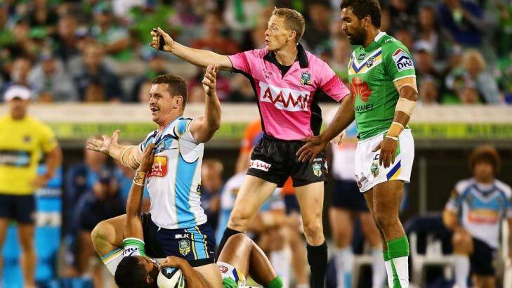 Greg Bird of the Titans struggles to get off the tackled player as referee Brett Suttor looks on. Photo: Getty Images