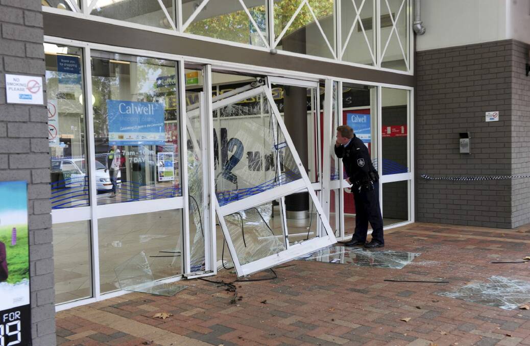 The aftermath of a ram raid of the Woolworths supermarket at the Calwell Shopping Centre. Photo: Graham Tidy