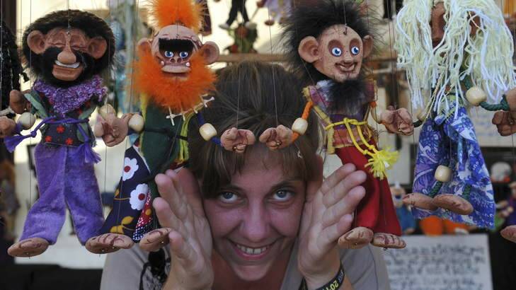 Sara Lee, of Byron Bay, selling her handmade marionettes at "The Squeaking Tribe" stall News. Thursday is set up day at the National Folk Festival. Photo: Graham Tidy